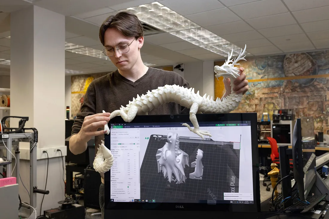 Student working on a 3D printed dragon.