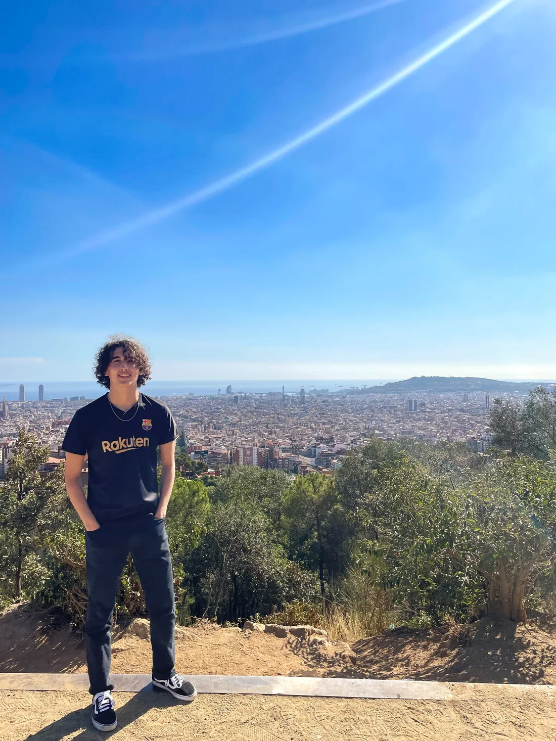 Adam Baltaxe standing and smiling in Park Güell in Barcelona, Spain.