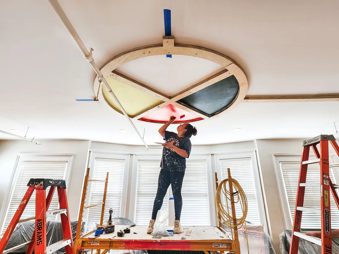 Student paints artwork on ceiling for renovation of 113 Euclid