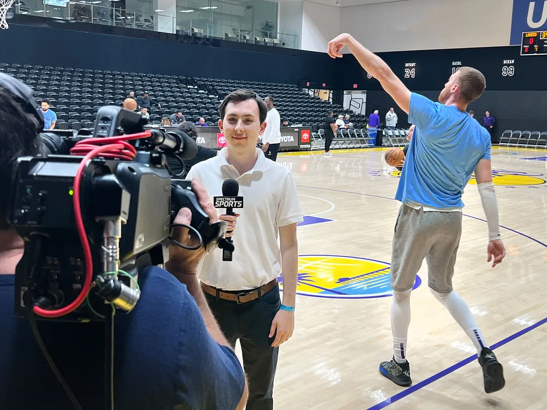 Luke Backman on camera at a basketball game in Los Angeles.