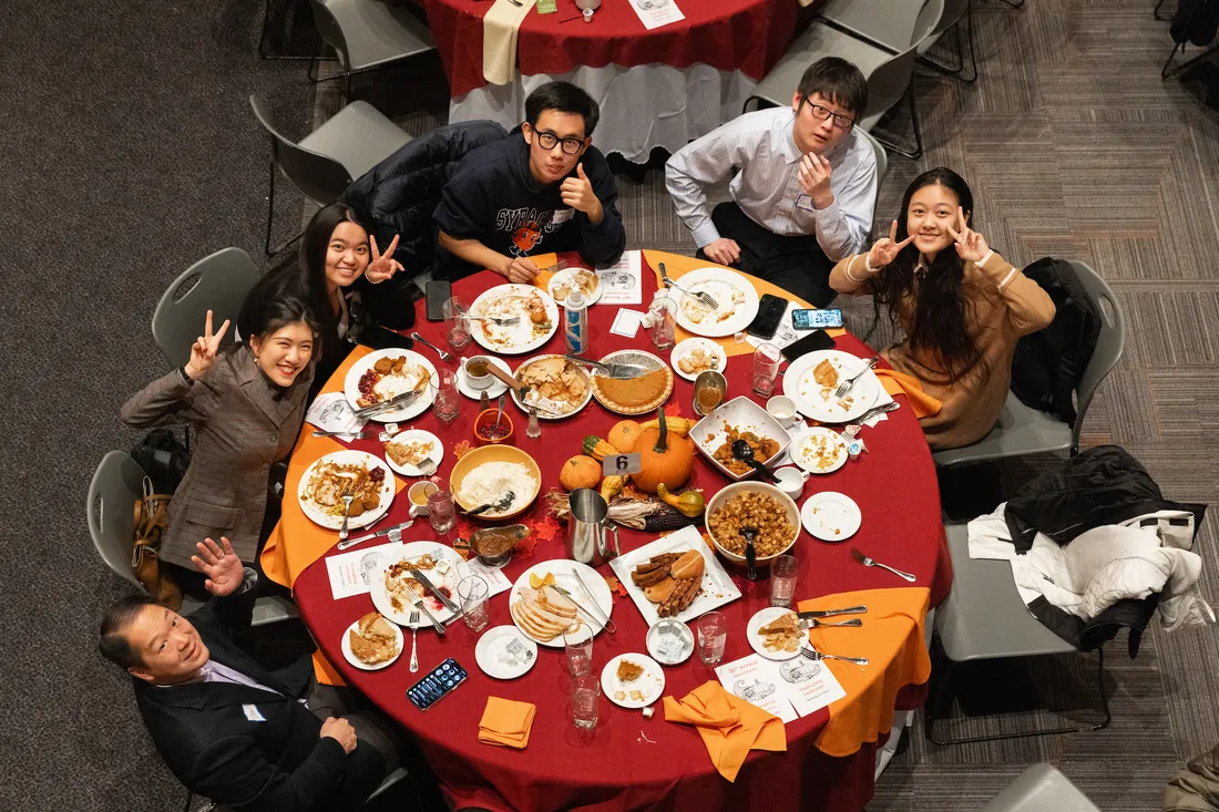 Students at a table eating dinner.